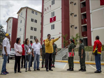 Esas casas, decoradas con gigantes retratos de Hugo Chávez que se ven desde...