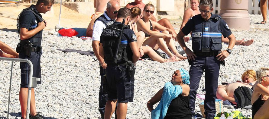 Las imágenes de unos policías obligando a una mujer musulmana a quitarse una camisa...