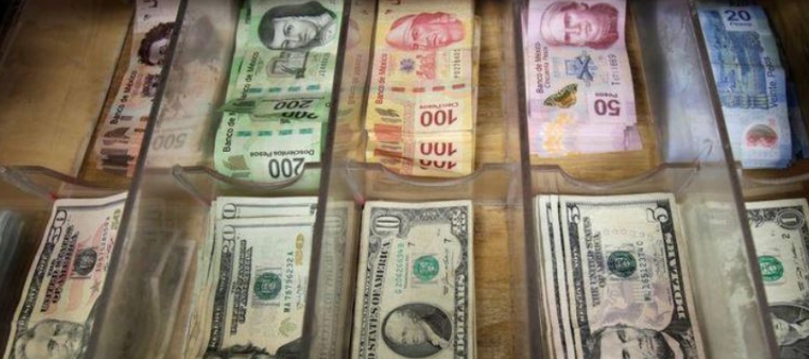 Imagen de archivo. Billetes mexicanos y dólares estadounidenses, en una casa de cambio de...