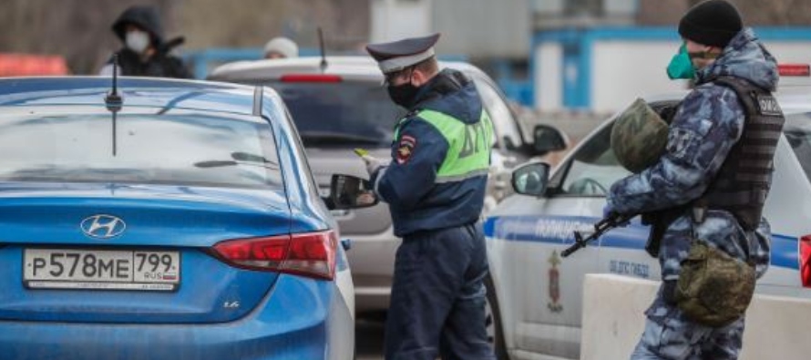 La policía rusa revisa los permisos de los vehículos en uno de los accesos a la...