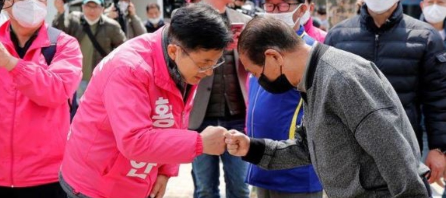 Hwang Kyo-ahn, a candidate of the main opposition United Future Party, gives a fist bump instead of...
