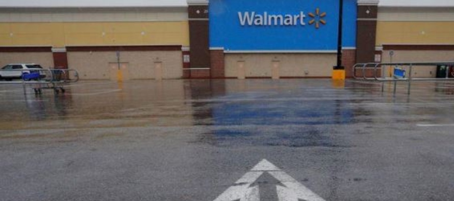 An arrow in the parking lot points to a Walmart Superstore, temporarily closed by an order from the...