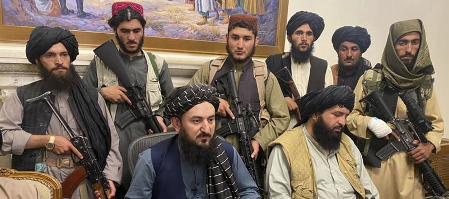 Combatientes talibanes fuertemente armados se desplegaron por toda la capital, y varios de ellos...